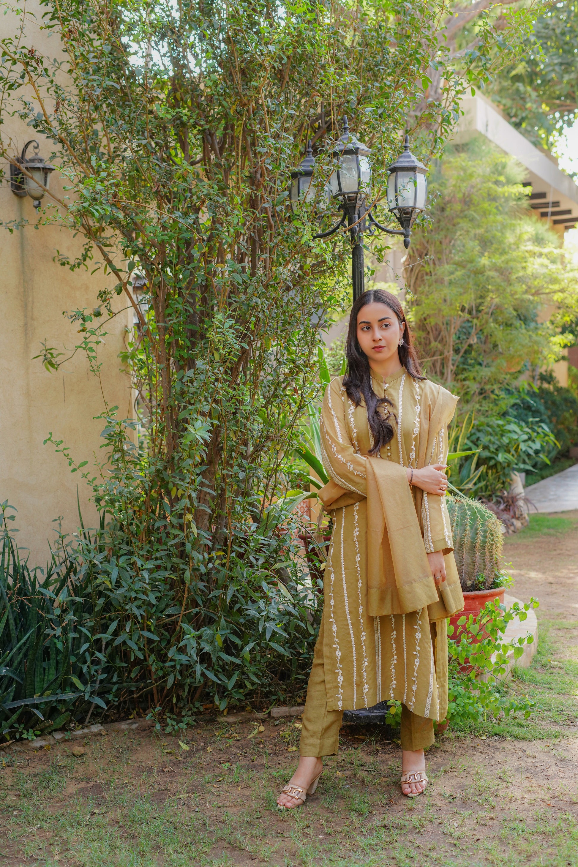 Chic mustard-yellow embroidered dress for women – stylish and modest outfit with vertical patterns, paired with matching pants and dupatta. Perfect for casual, formal, and festive wear. Shop modern modest clothing online.