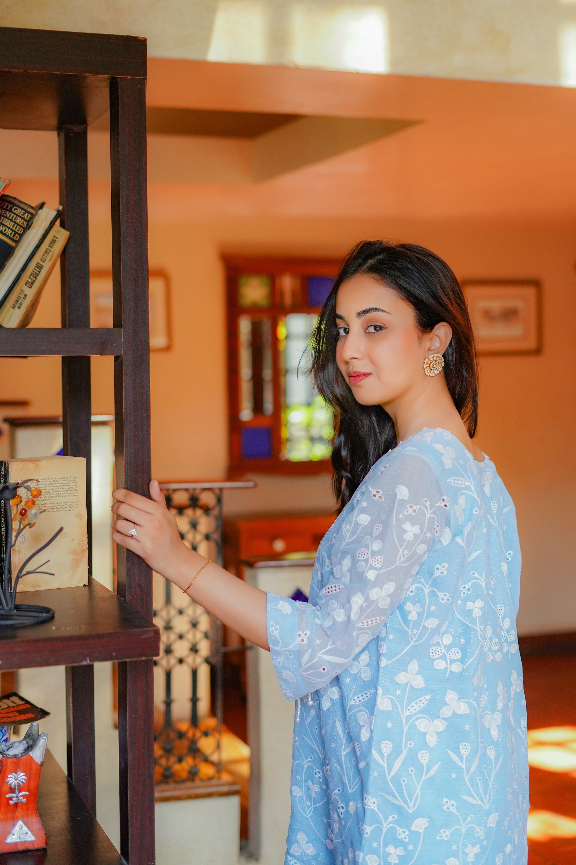 Light blue embroidered tunic with floral patterns for women – paired with cream-colored pants and heels. Perfect for casual and semi-formal occasions. Shop elegant and modest women's clothing online.